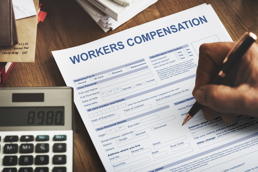 man fills out workers compensation form