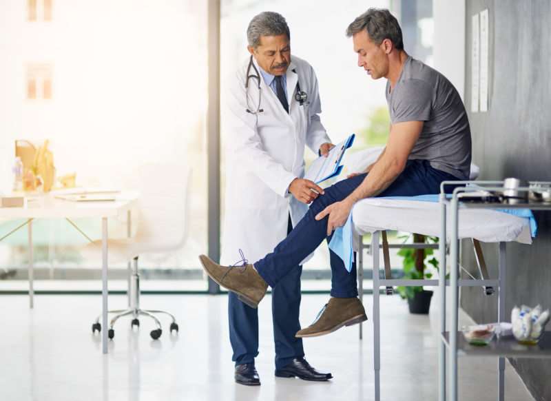 man being seen by a doctor after a work injury in Charleston, SC