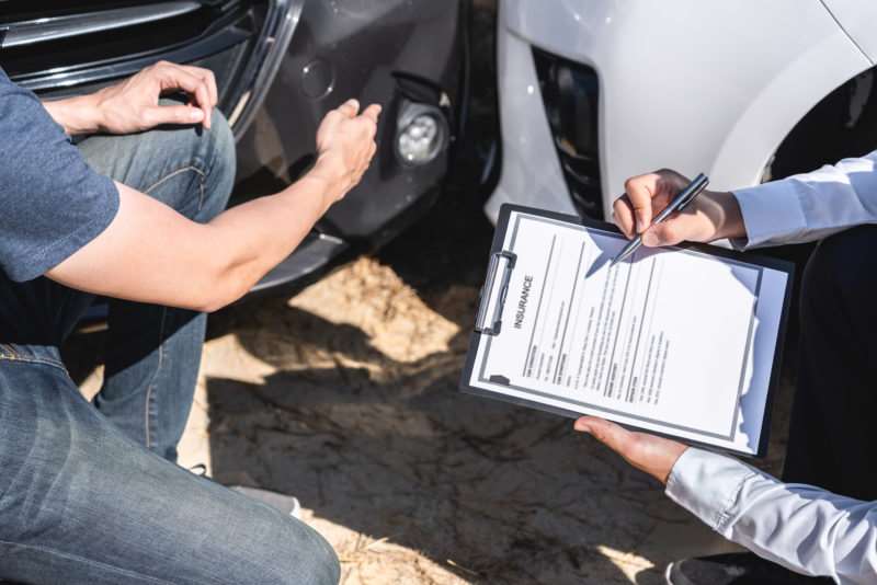 a man meeting with an insurance adjuster after a Charleston car accident