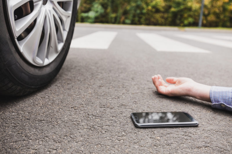 injured pedestrian lying in the road after an accident