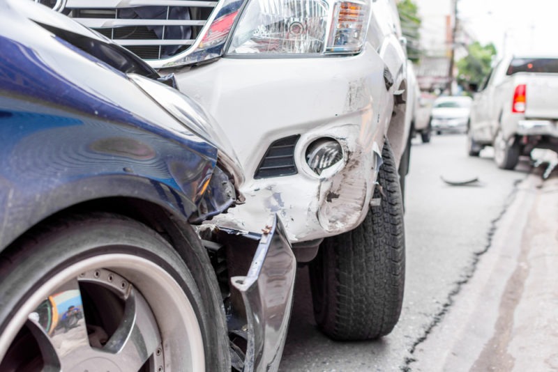 closeup of a car and a large truck after a collision