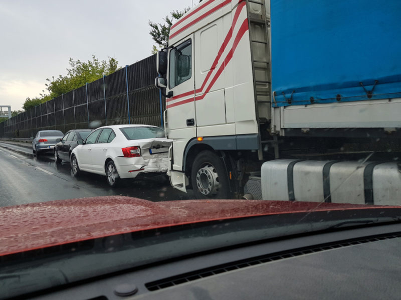 truck rear-ending car in rain