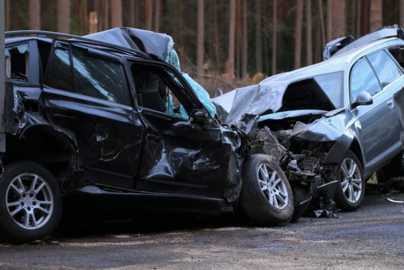 two wrecked cars after head on collision