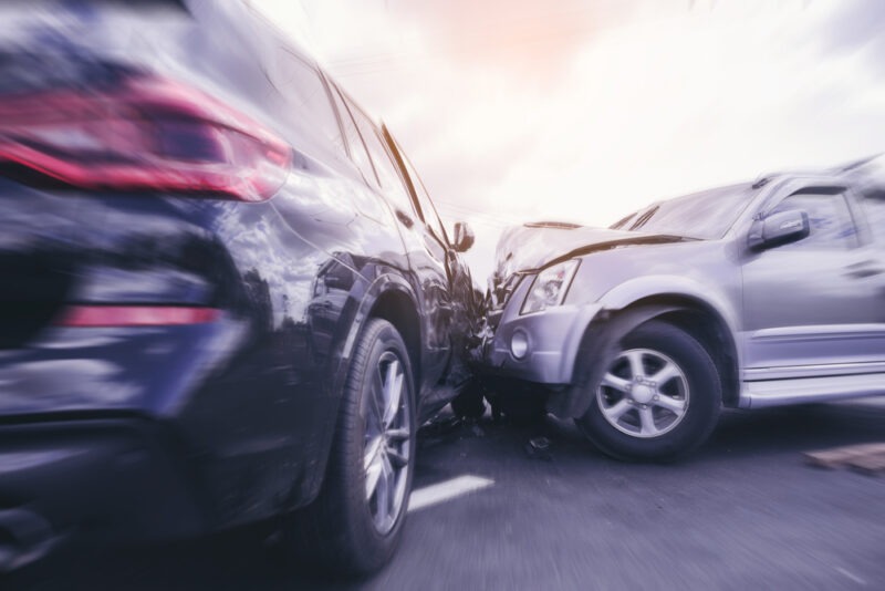 A close-up of two cars colliding.