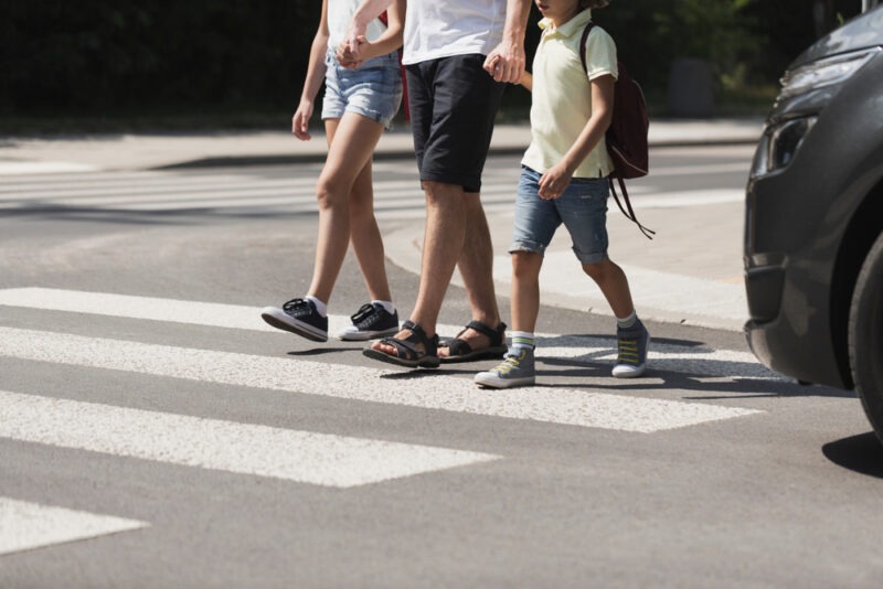 A family crossing in front of a car. Find out what to do if you’re hit as a pedestrian with our legal team. 