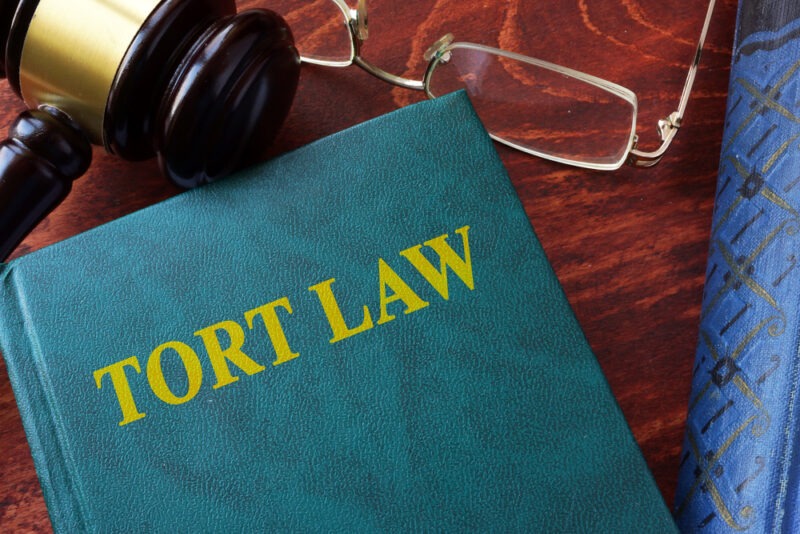 A book titled “tort law” sits on the desk of a mass tort lawyer.