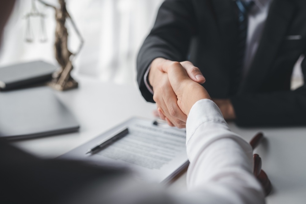 A person shaking hands with a dog bite attorney.