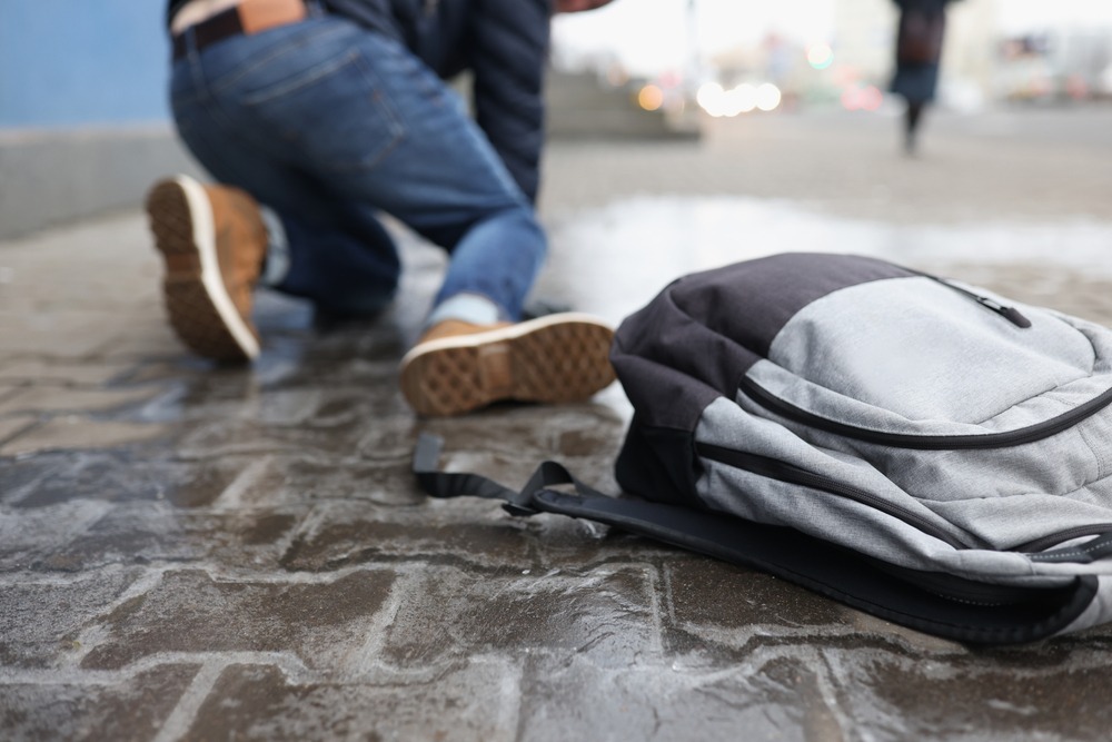 A person lays on the ground after a slip and fall and wonders how negligence is proven in this claim.