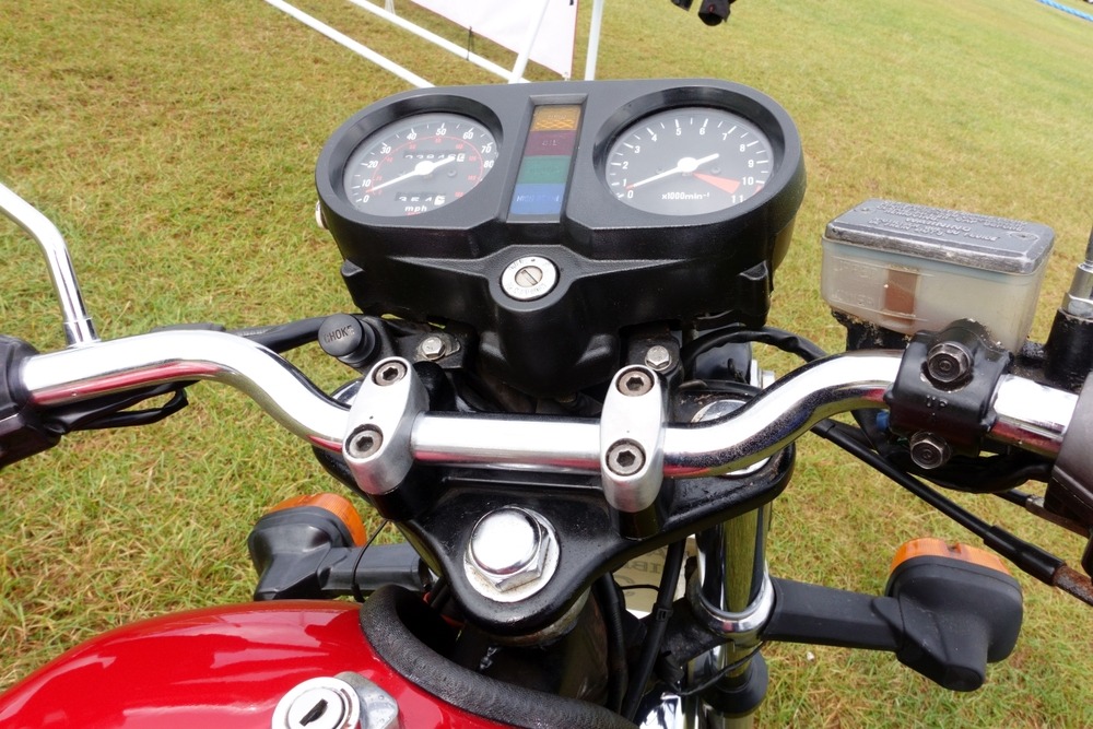 The instruments and handlebar on a classic Honda 250N Delux Super Dream motorcycle at a vintage show in Carew, Pembrokeshire, Wales, UK