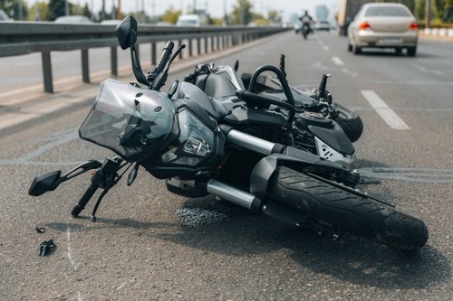 A motorcycle lying on a highway after a collision, an incident requiring a Charleston motorcycle accident lawyer.