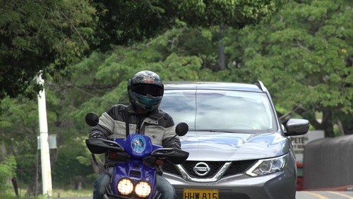Charleston motorcycle tailgating accident showing a car following closely behind a motorcyclist on a public road